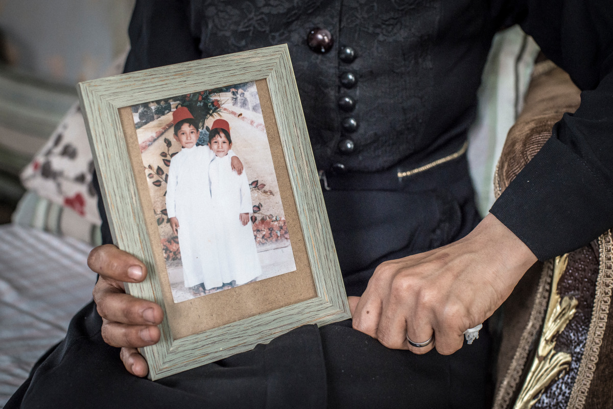 Amira showing a picture of her sons. Her oldest was killed in a bombing. 