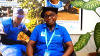Elisabeth, HI community liaison agent and deminer in Casamance, Senegal Portrait of Elisabeth, sitting in front of demining posters and smiling at the camera.