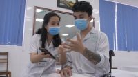 A rehabilitation professional shows a patient how to use the OpenTeleRehab mobile app in Vietnam.  A rehabilitation professional shows a patient how to use the OpenTeleRehab mobile app in Vietnam.