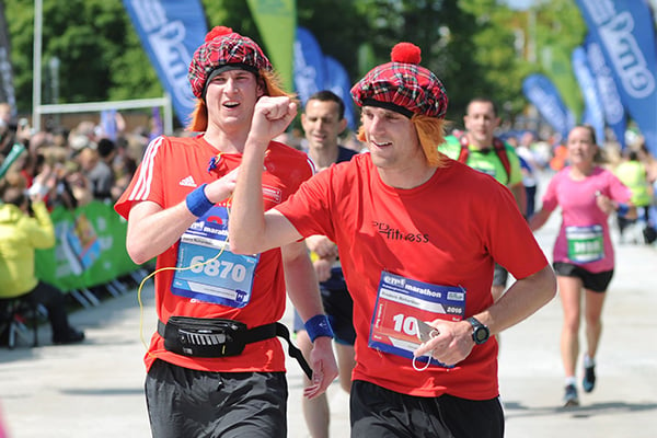 Runners wearing hats and wigs at Edinburgh Half Marathon's finish line