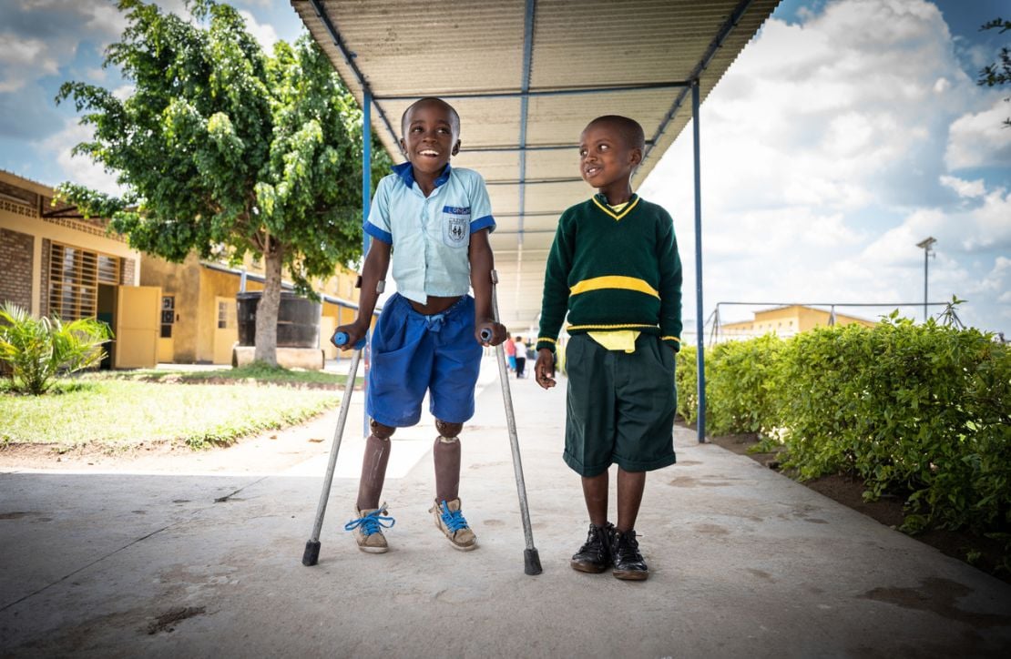 Longini and his friend walking down a path at school