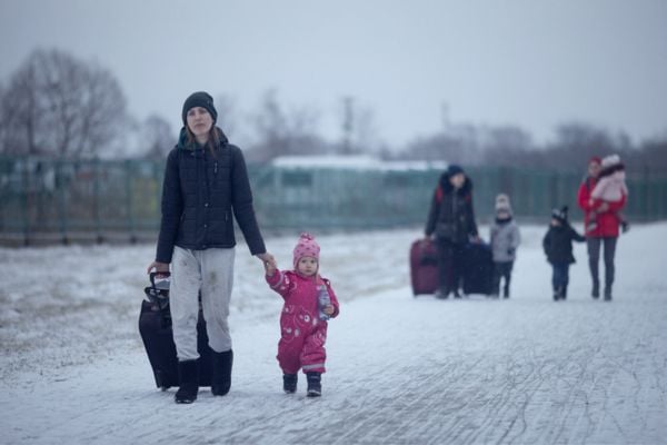 A woman and her child walking through the snow to the Ukraine border.